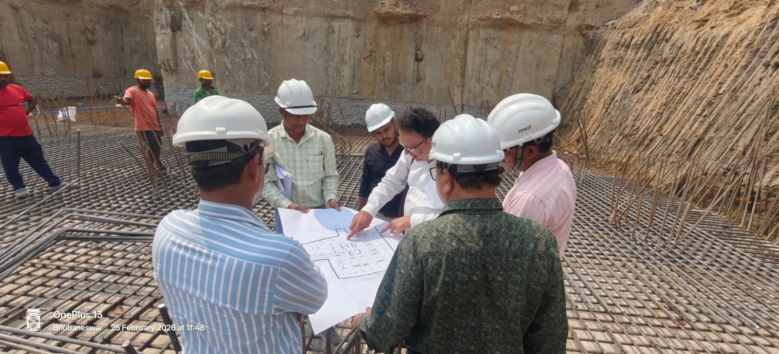 Engineers reviewing structural drawings on a live construction site